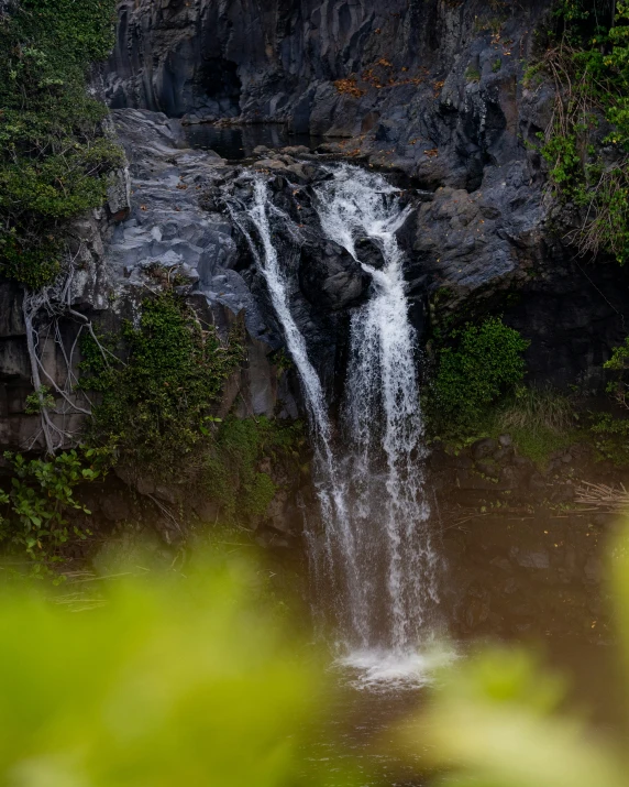 a waterfall is coming out of the ground with some water