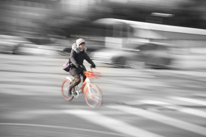 a person riding on a bike with a hand bag
