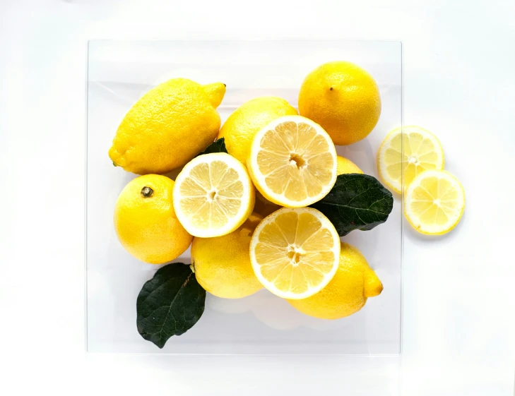 a picture with many lemons on the white table