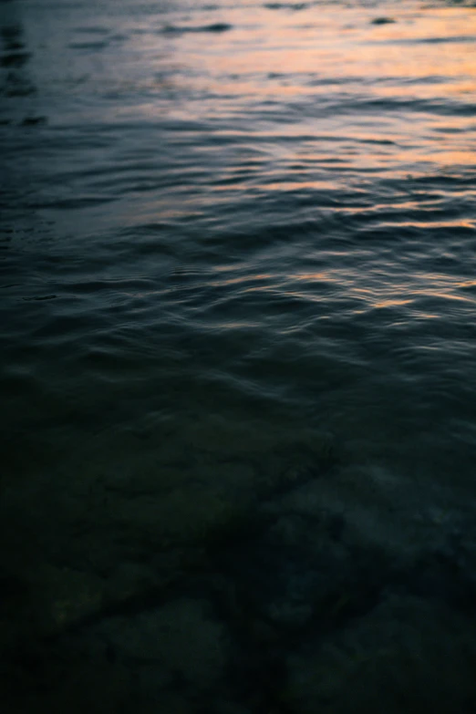 an ocean scene with waves and orange glow