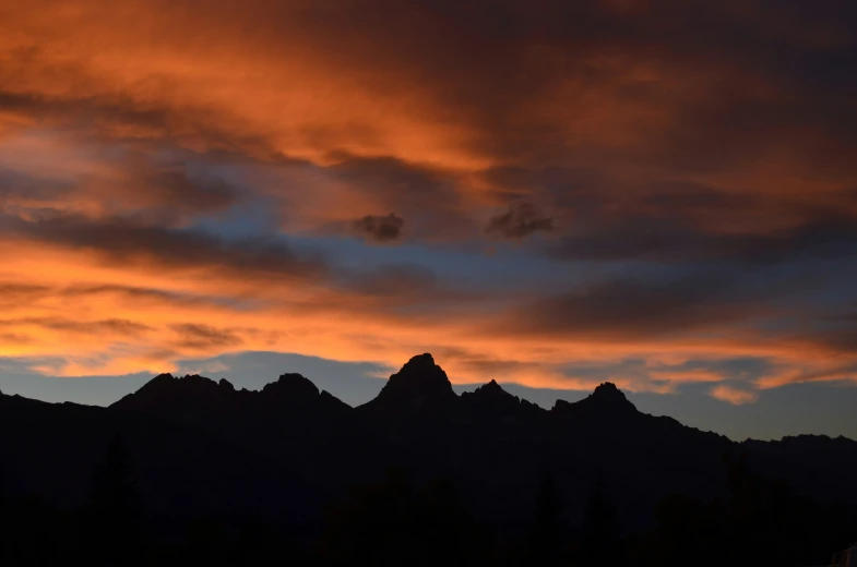 a sunset po shows red clouds over mountains