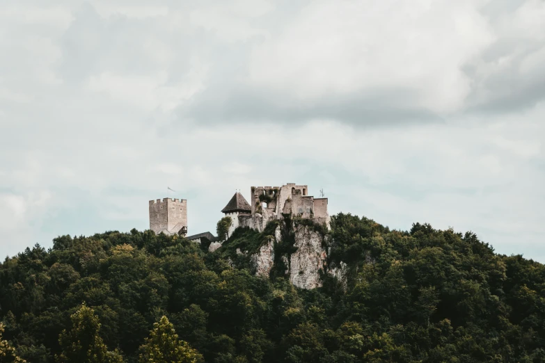 an old castle in the middle of trees and hills