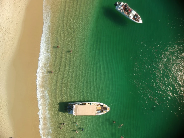 several boats are parked on the side of a beautiful beach