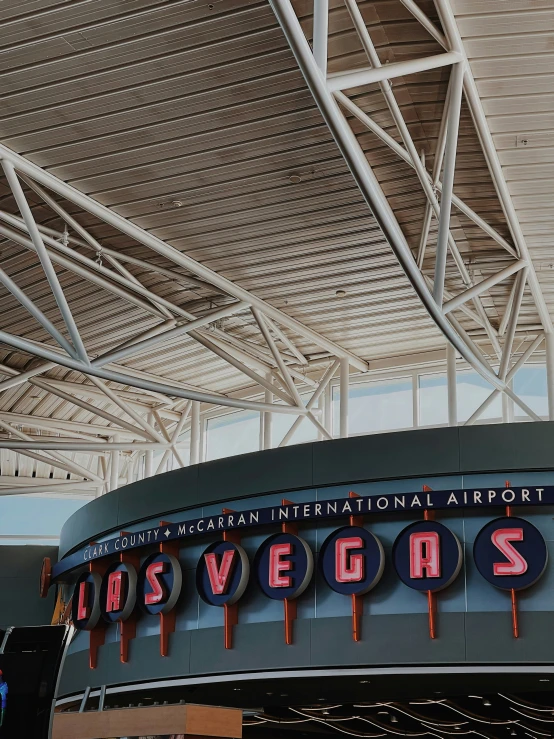 an empty building with overhead roof signs at the airport