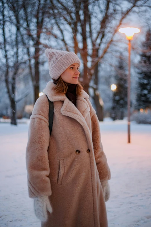 the woman is wearing a hat and jacket