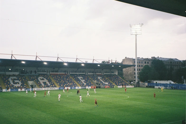 players playing soccer on the field in a stadium