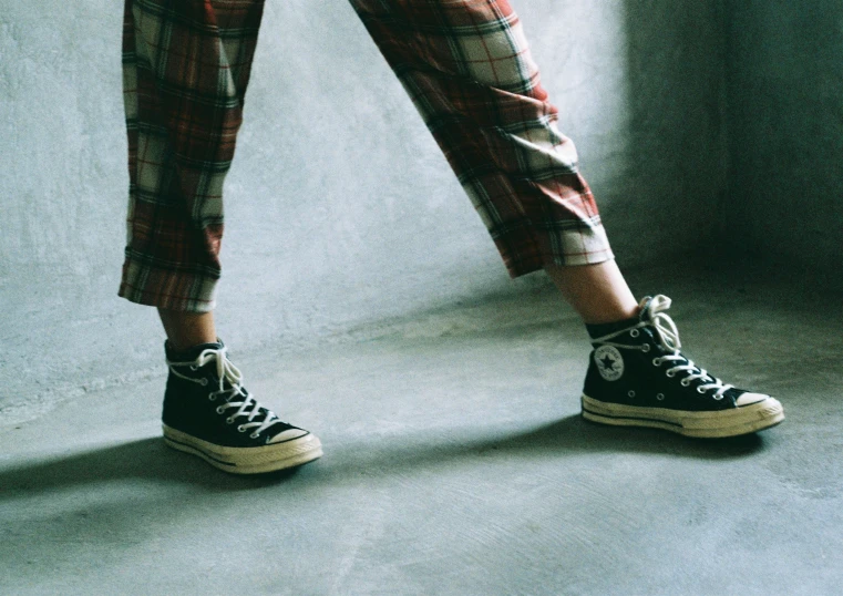 the feet of a person in black sneakers