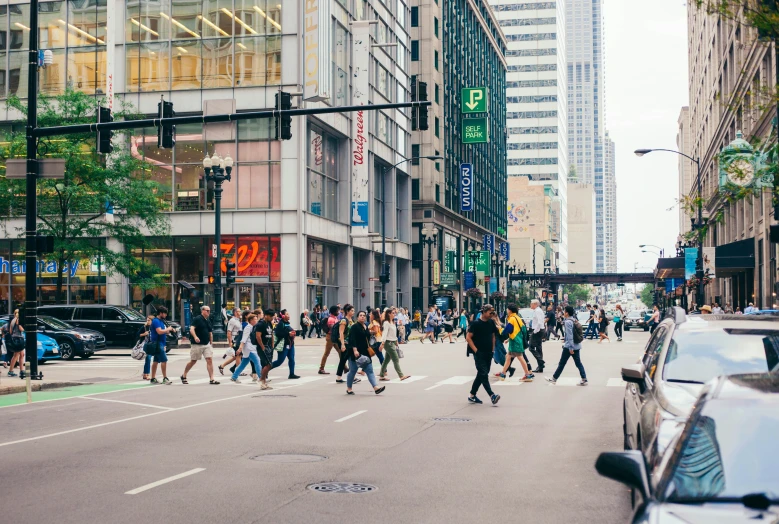 a group of people crossing the street in an intersection