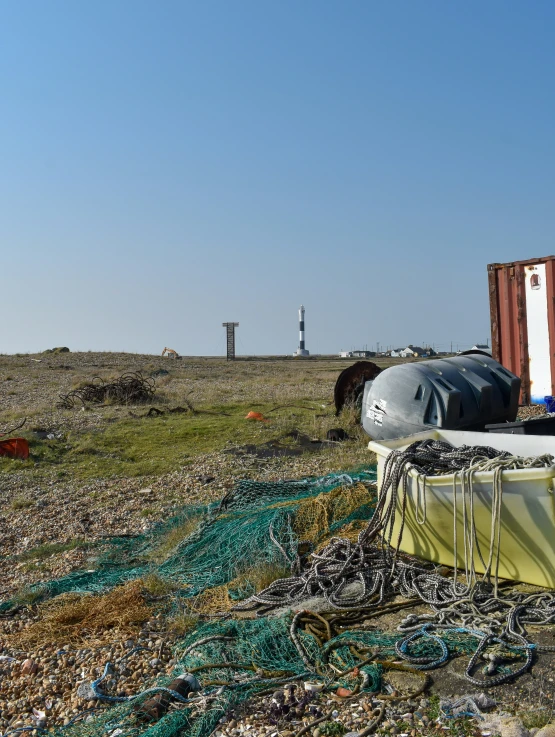 a container that is sitting on a beach near grass