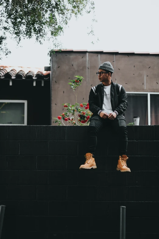 the young man sits on top of the building