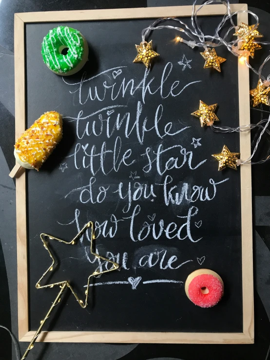 a chalkboard sign that has some doughnuts on it