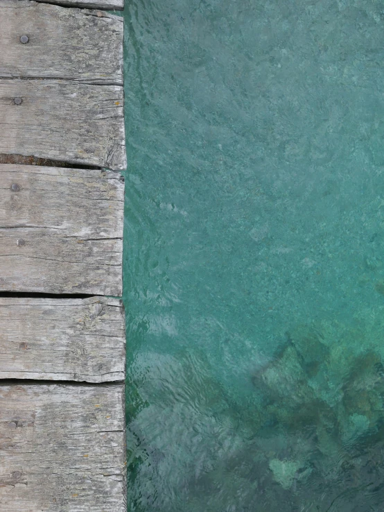 view down into the ocean from a dock