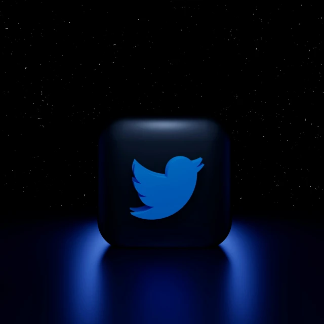 a dark blue twitter icon on a black background