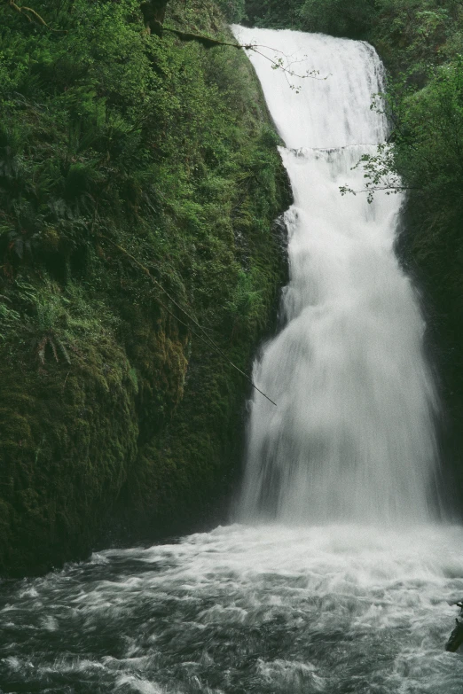 a person standing in front of a waterfall