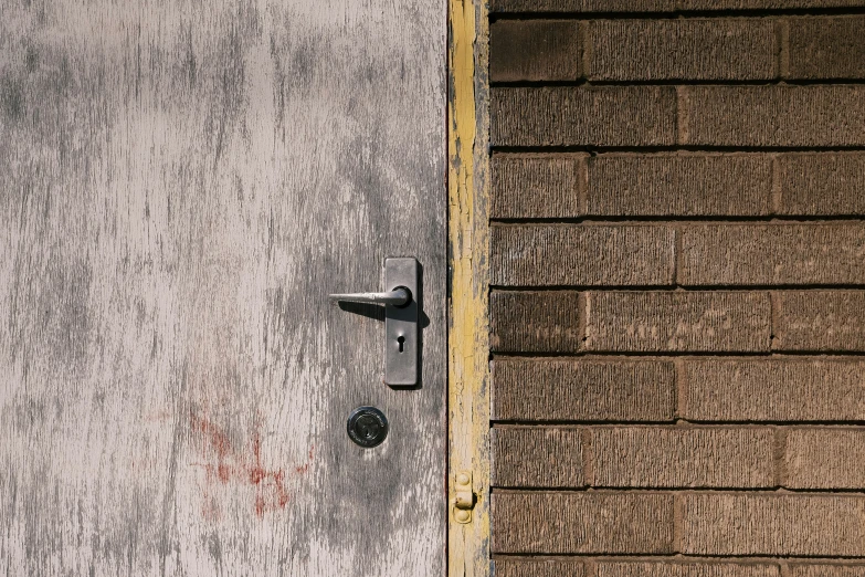 a door is open on a wall in front of a house