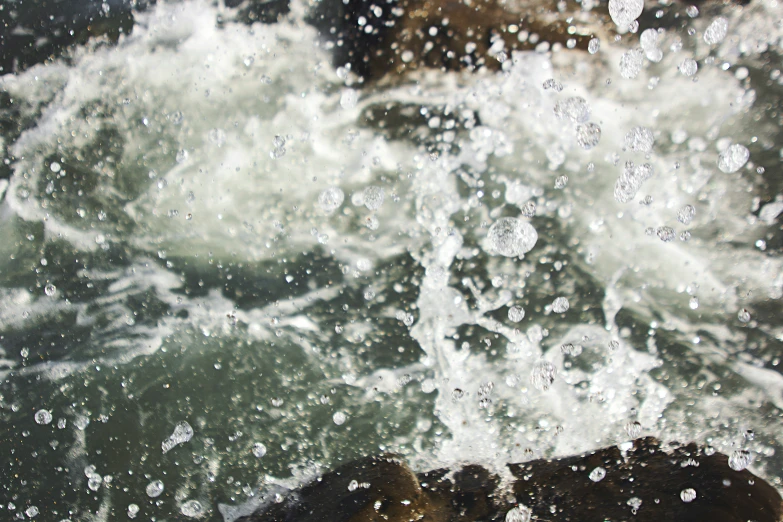 the water splashes down the rocks, creating some sort of patterns