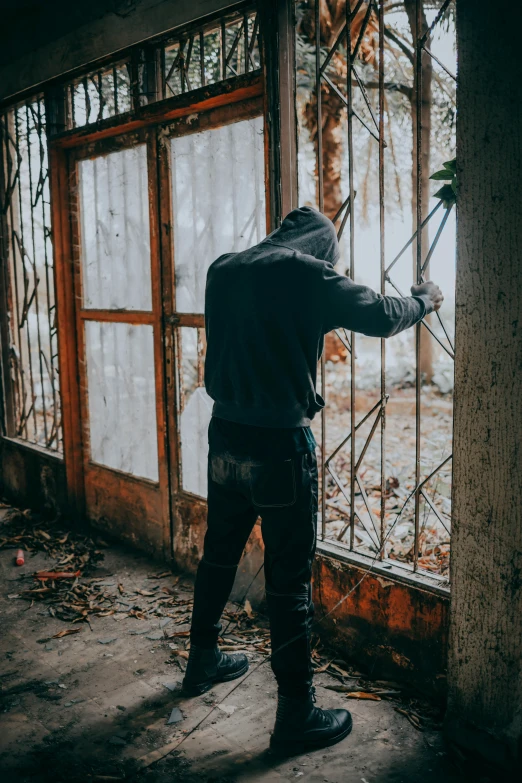 a person in black clothes in front of a building