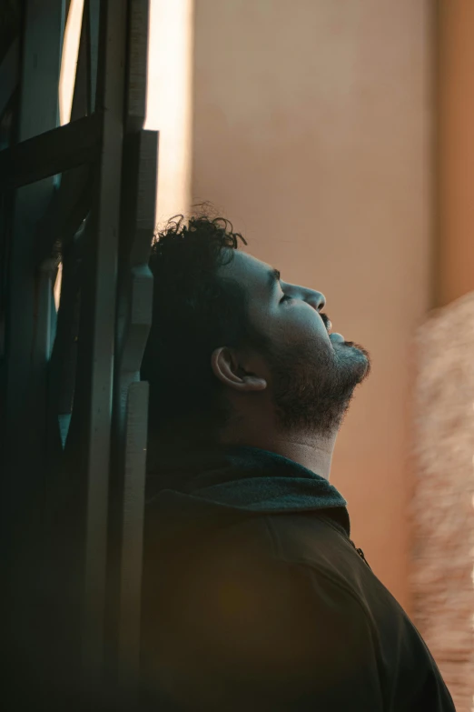 a man looking off into the distance near a fire place