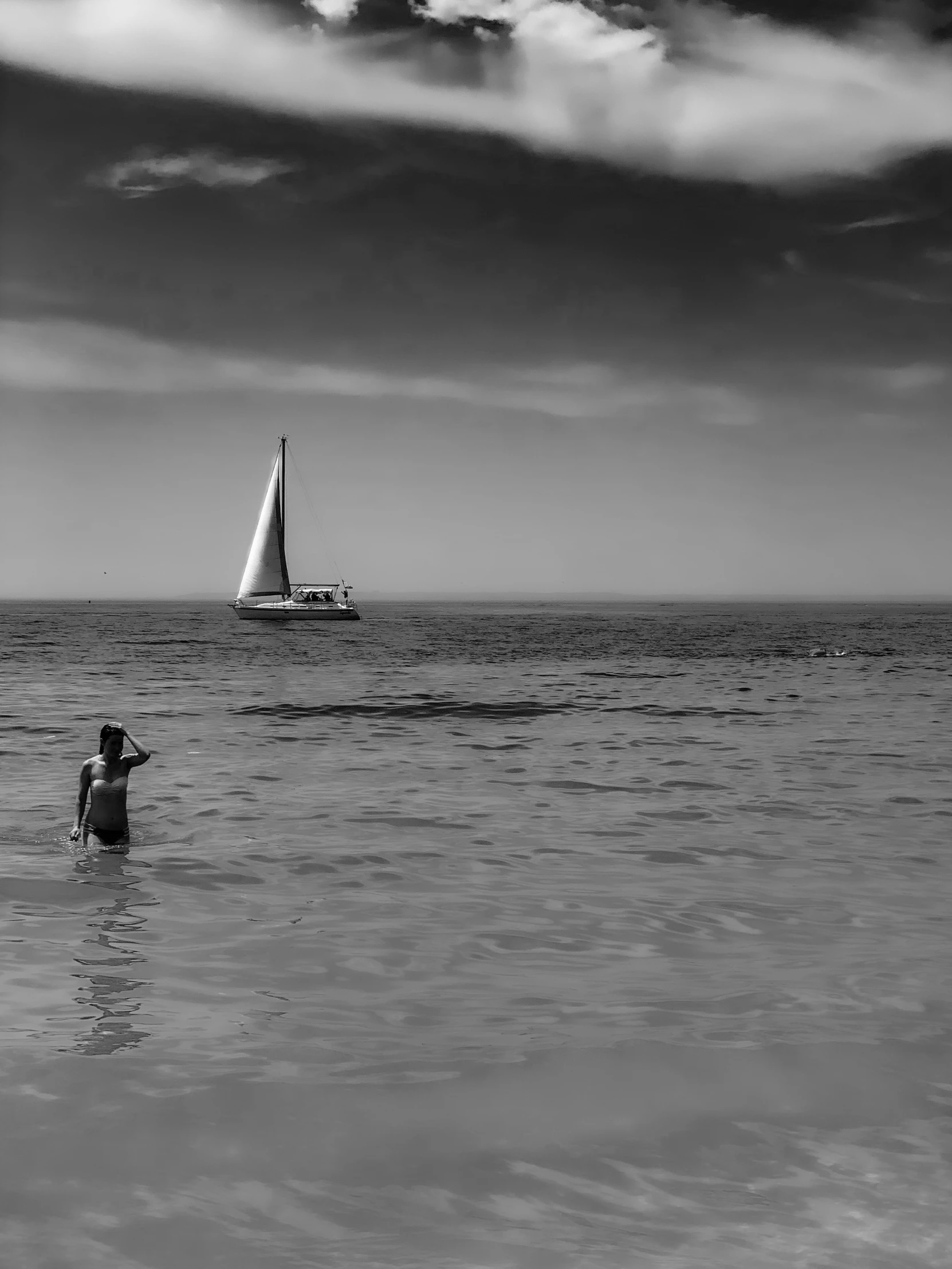 a black and white po of a sailboat on the water