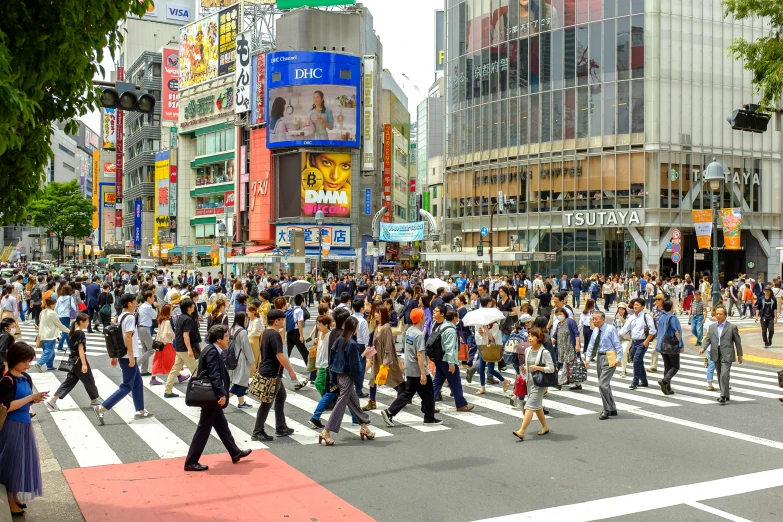 there are many people walking around the city crosswalk