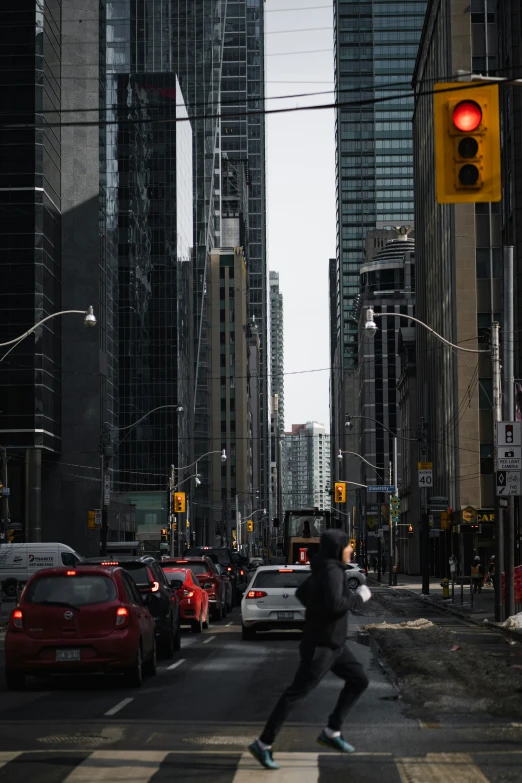 a young man skateboarding through traffic in the city