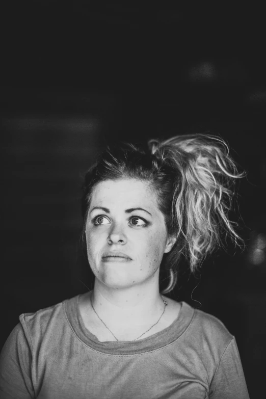 a woman in a top knot looks away from the camera