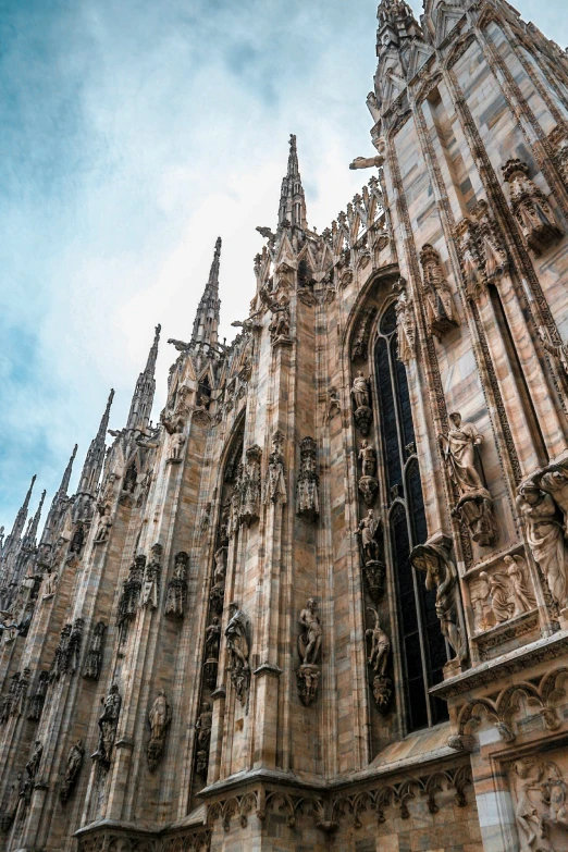 a gothic styled cathedral with clocks, sculptures and decorative elements