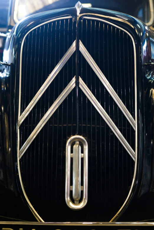 the grille of an antique car with gold trim