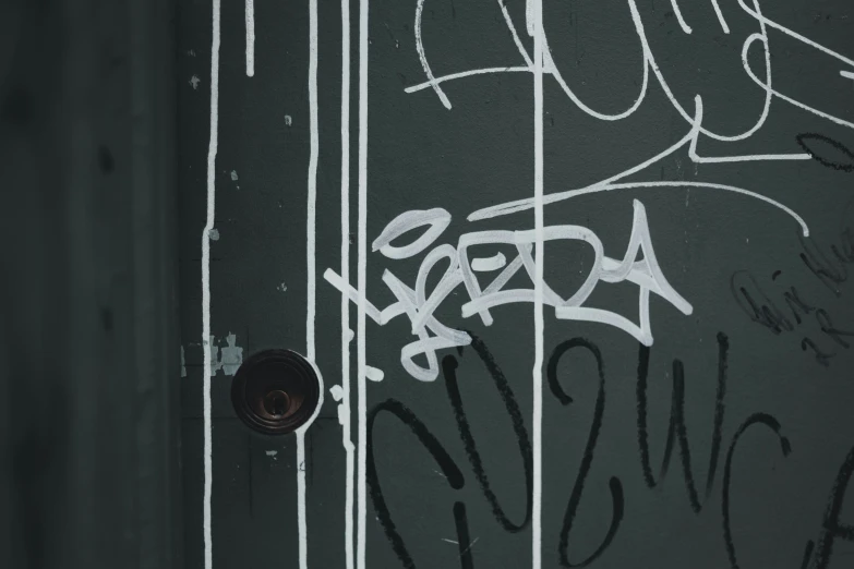 some white graffiti on the side of a door