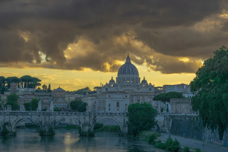 a sunset po of a castle and an arch across a river