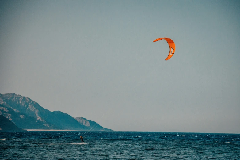 a para - surfer is in the middle of a blue ocean