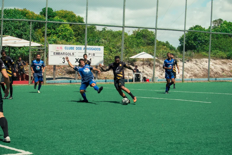 group of young men playing a game of soccer on field