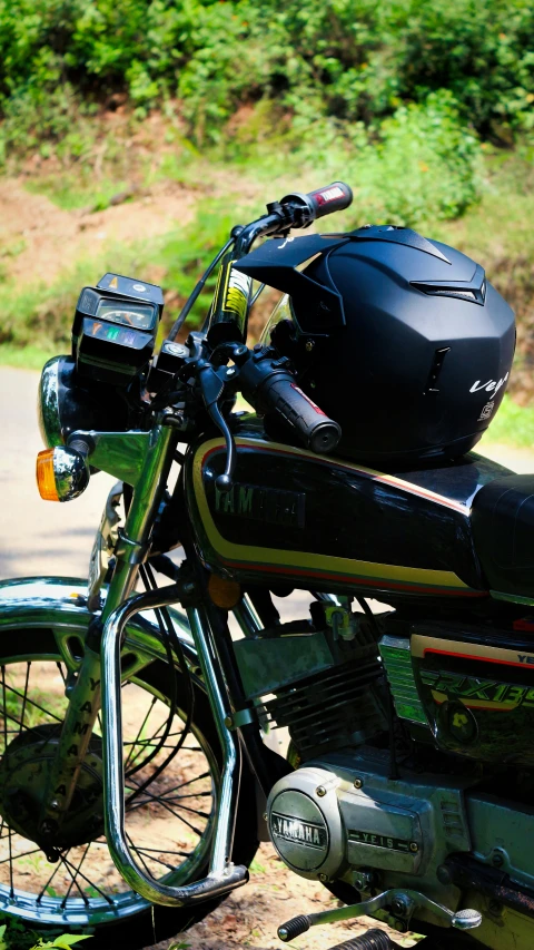 a motorcycle parked next to a tree filled forest