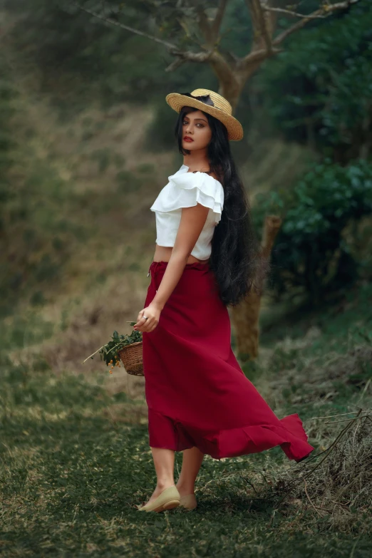 a woman wearing a straw hat and dress