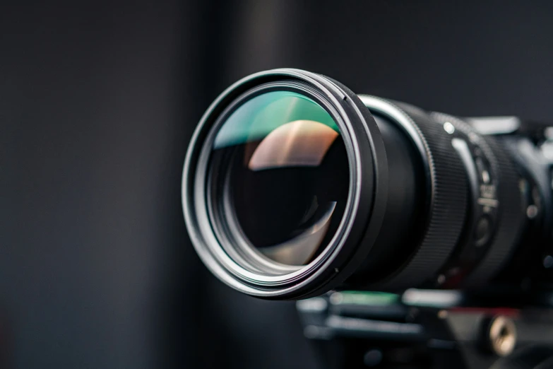 a lens pointed into the sky that is being attached to a camera