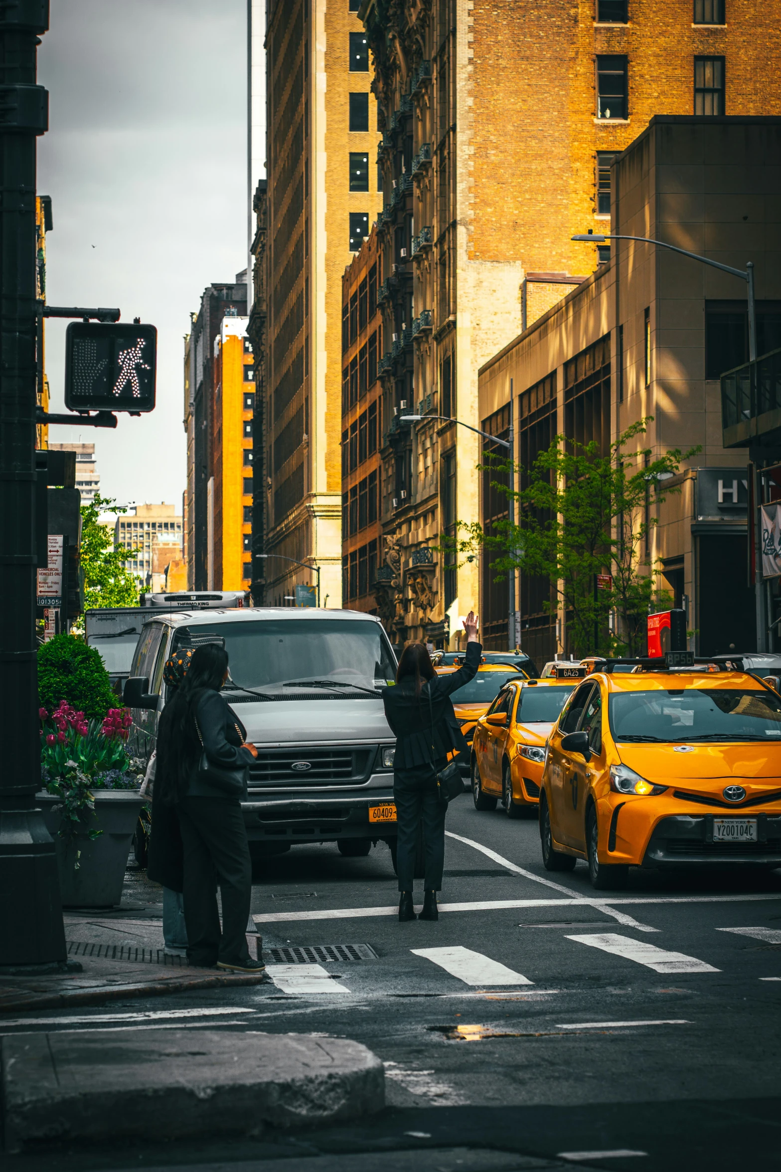 a group of people crossing the street in a city