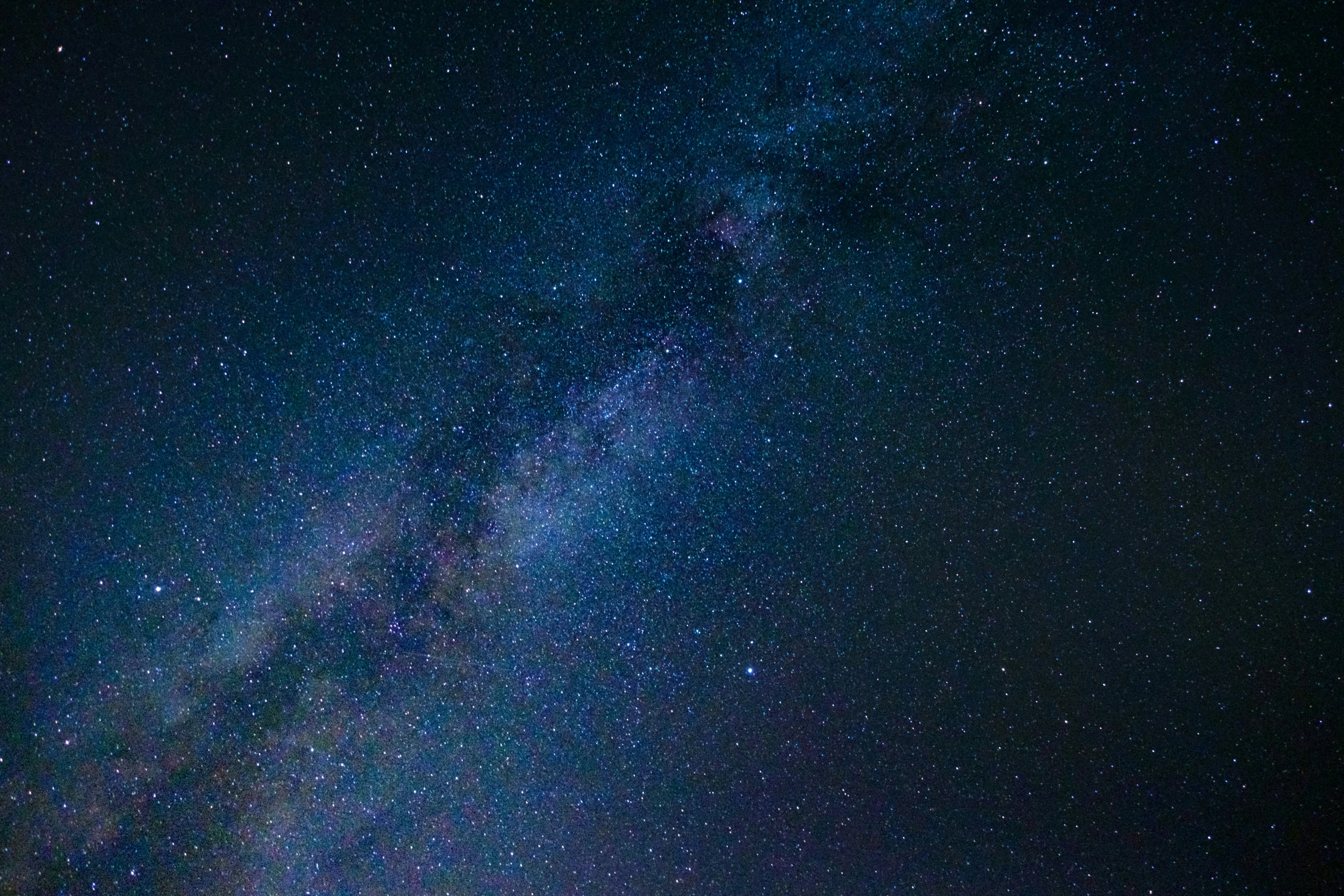 the night sky shows a single dark - blue - blue line, while a few light brown lines, and white dots, creating a faint dot, on the lower center of the blue line, green space