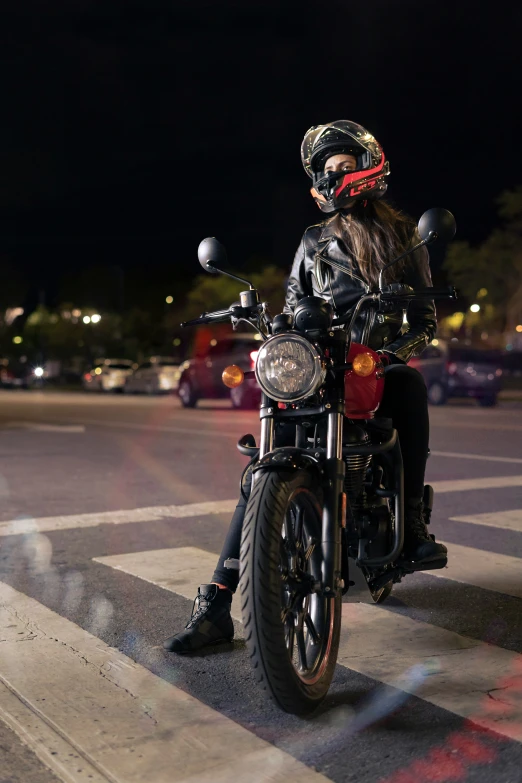 a man with long hair sitting on a motorcycle