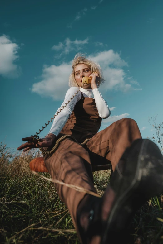 a young woman sitting in the grass eating food