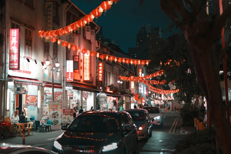 the city streets are lined with small businesses at night