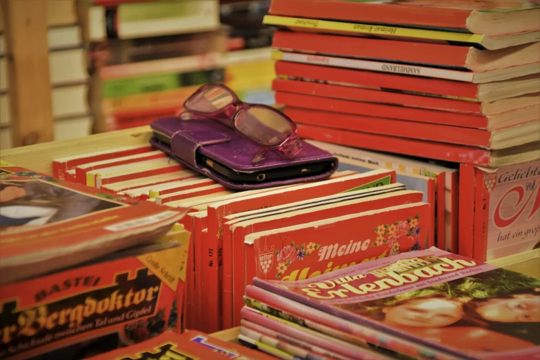 a stack of books that have glasses on top of them