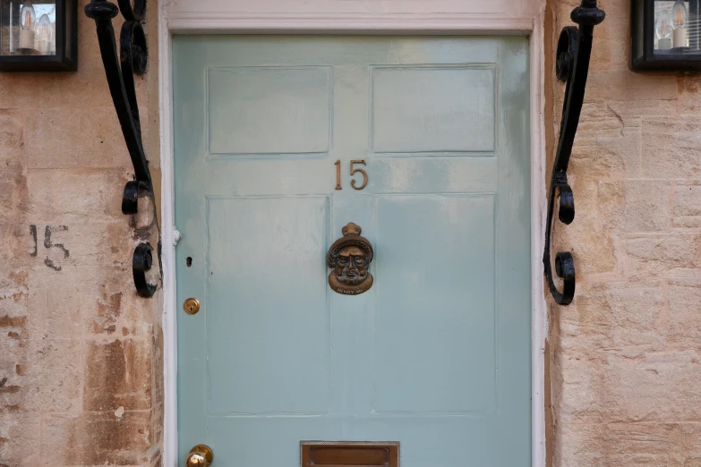 blue door to an apartment building with numbers 15 on it