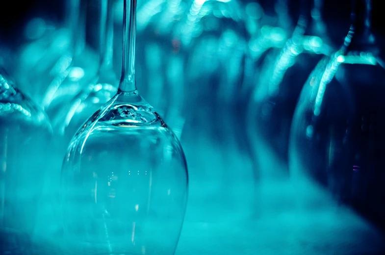 a line of wine glasses with a blurred background