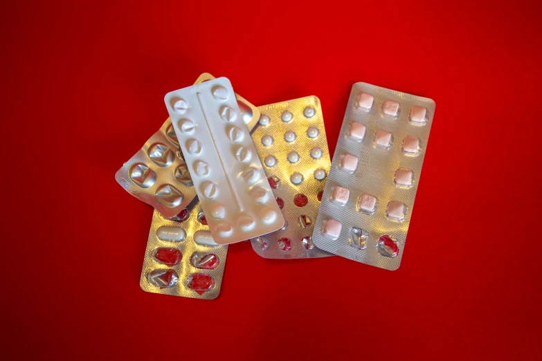 pills on top of a set of five packets