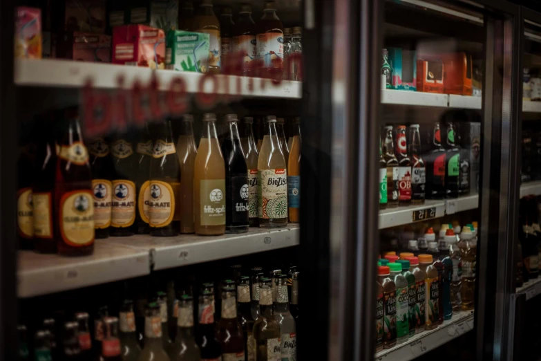 bottles and cans of alcohol are stacked up on shelves