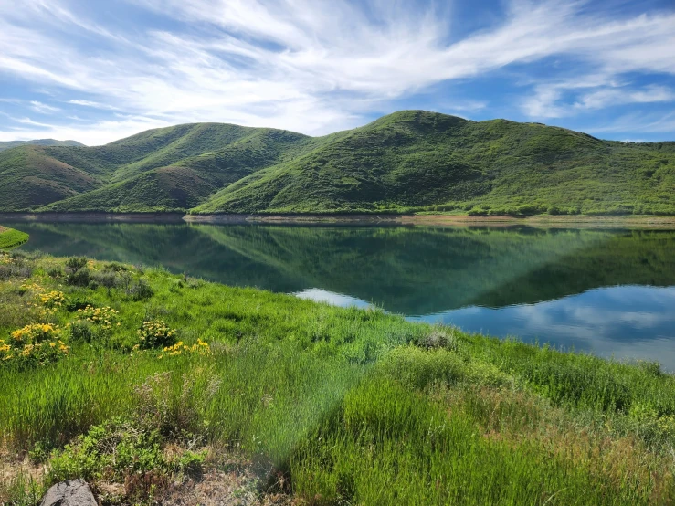 green hills and a lake that looks like a lake