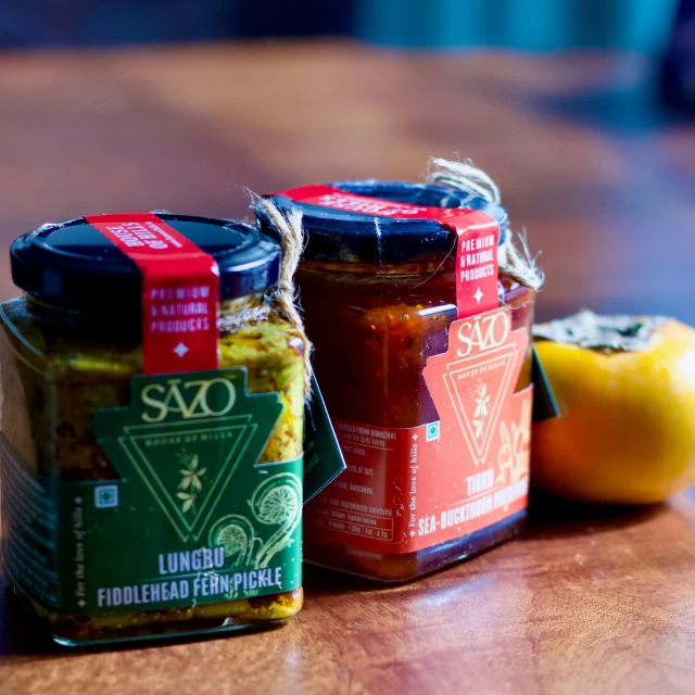 several jars are on a table, with two yellow oranges