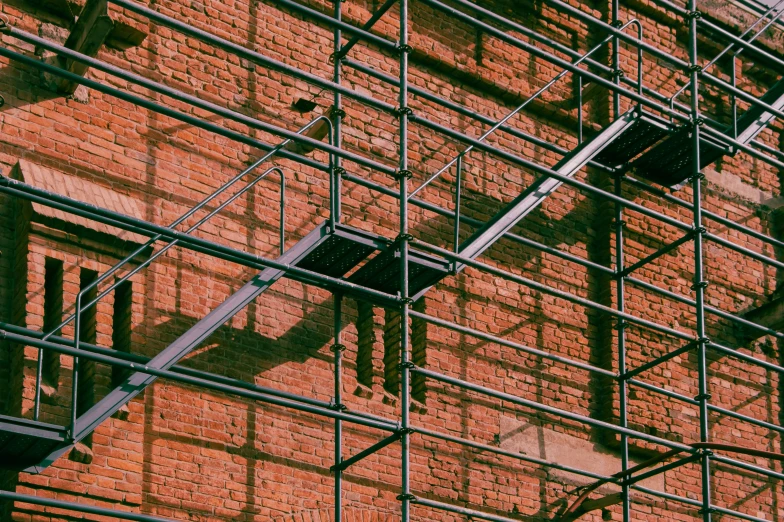 an image of a scaffolding outside by some bricks