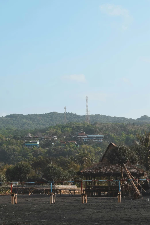 the hills are covered in trees next to the building