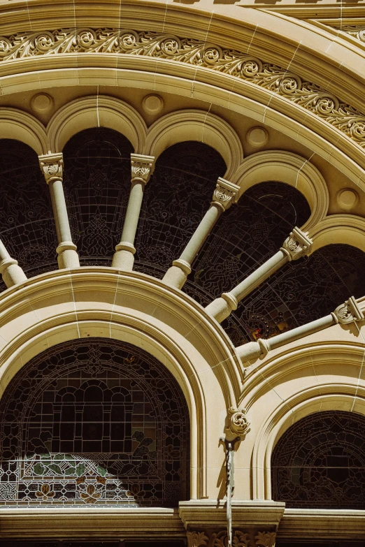 an arched window of a building with decorative ornaments